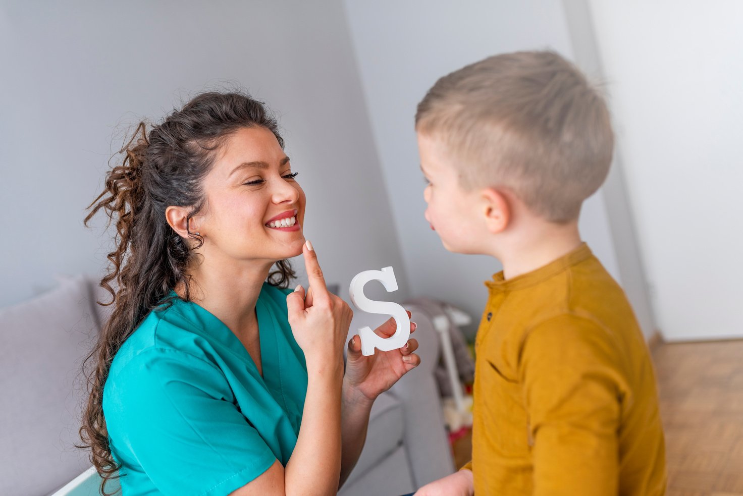 Speech therapist and little patient training articulation