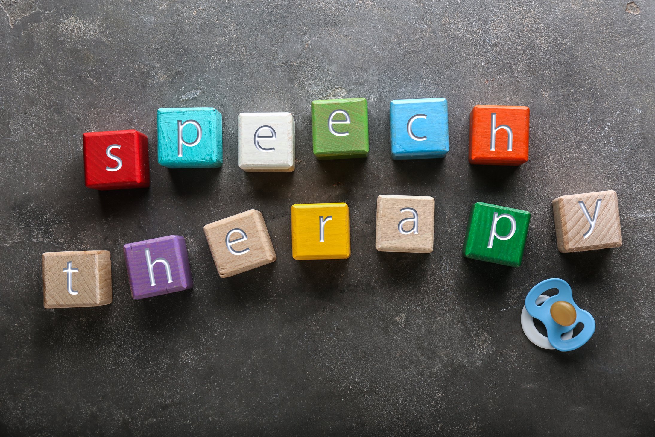 Cubes with Text SPEECH THERAPY on Grey Background